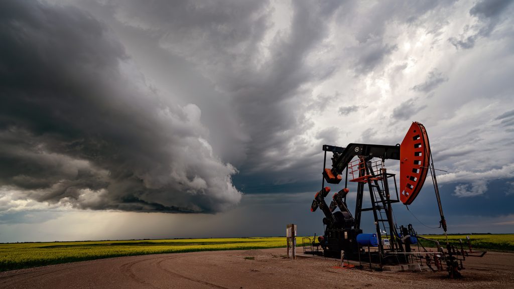 Storm clouds are seen over a pump jack rig