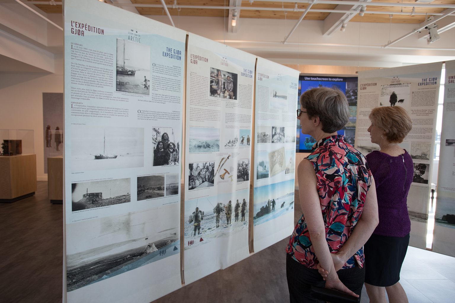 Two women read exhibit displays about polar explorer Roald Amundsen at 50 Sussex drive