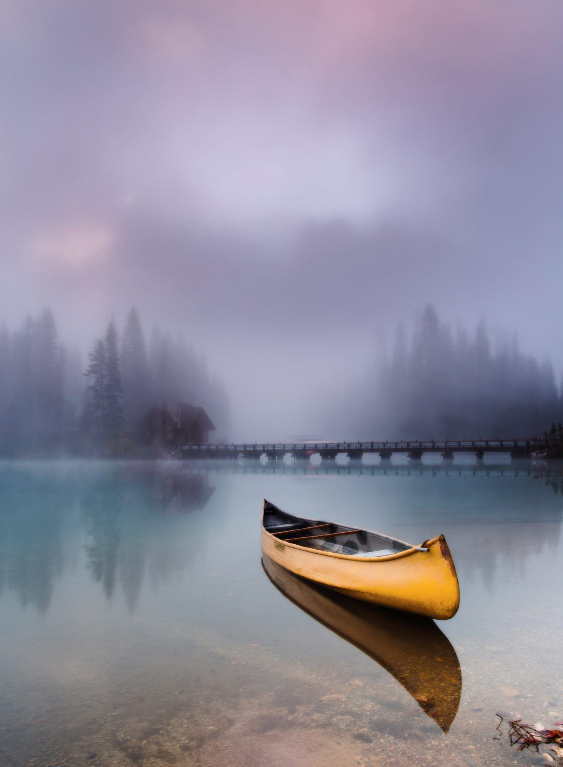 A canoe floats on the perfectly calm surface of Emerald Lake in B.C.'s Yoho National Park. Photo by Evgeny Chertov