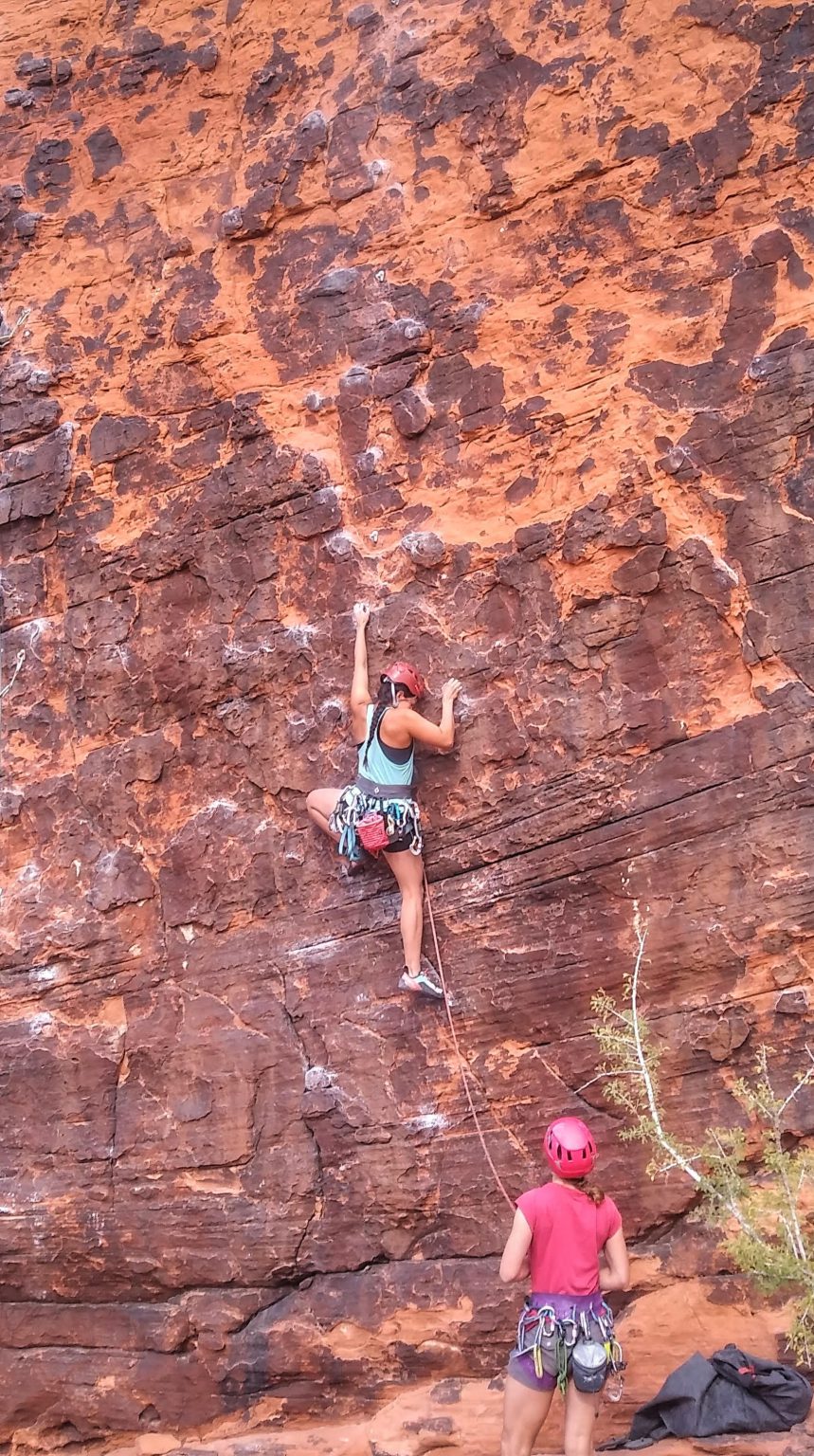 Female climber on red rock face