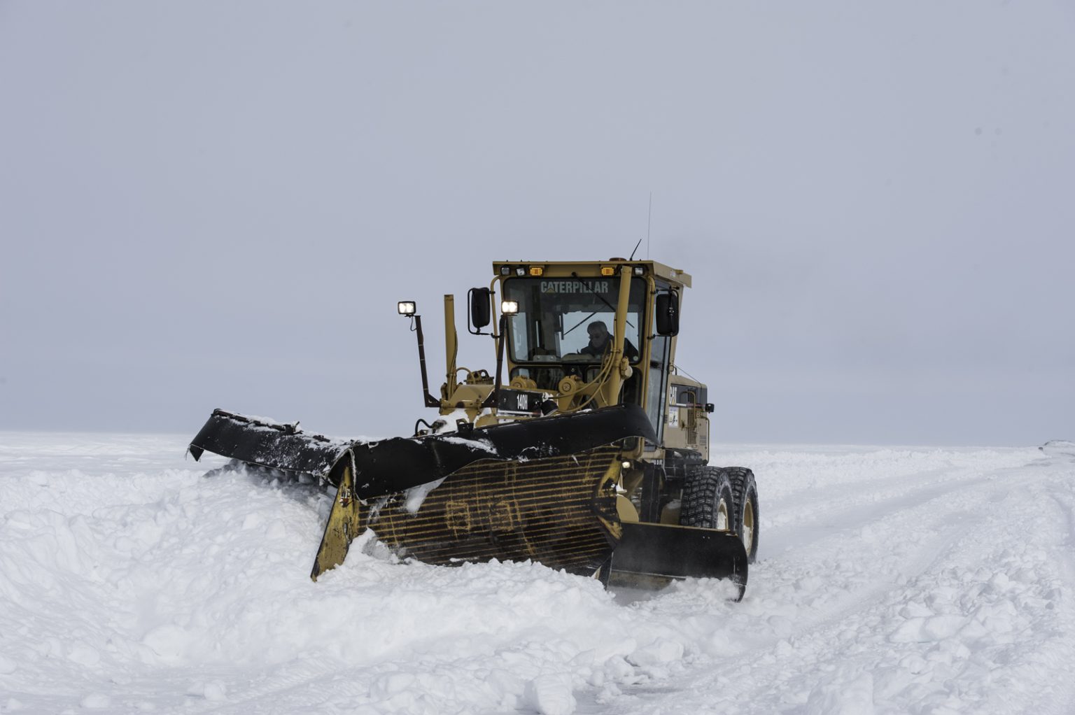 A snowplow clears the ice road between Tuktoyaktuk and Inuvik