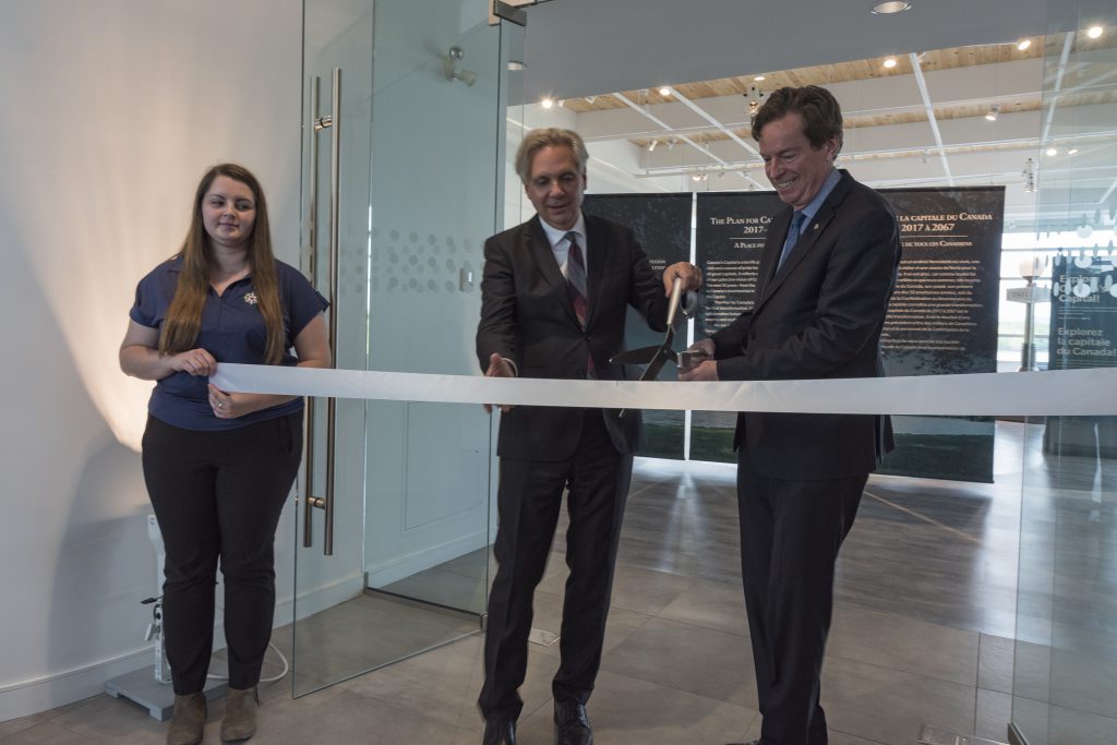 Mark Kristmanson and John Geiger cut the ribbon to officially open 50 Sussex