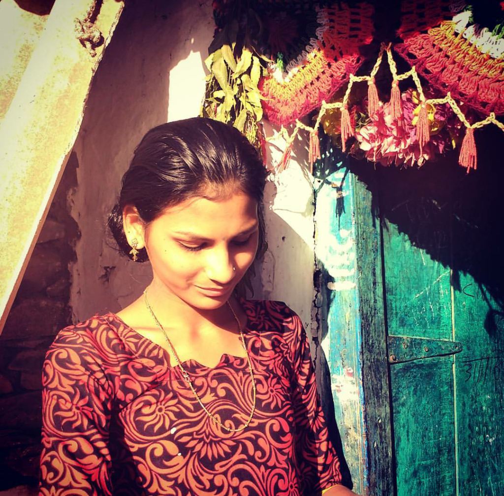 A member of the Mahila Samakhya program outside her home.