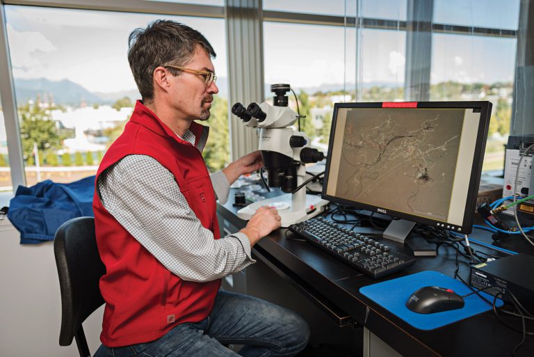 Ross in the Vancouver Aquarium Marine Science Centre analyzing water samples. Credit is: Steven Hargreaves