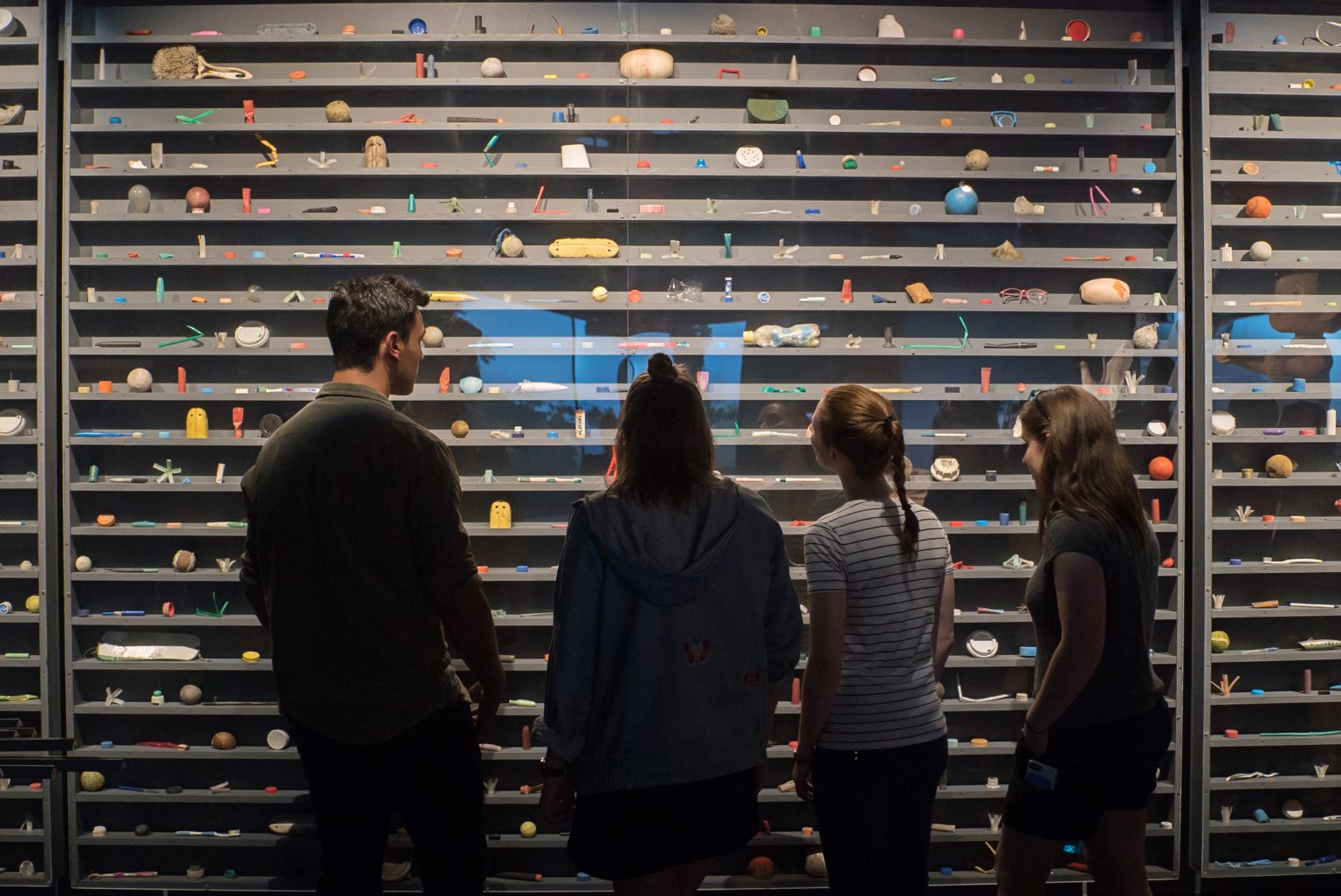 Visitors examine a display of plastic debris recovered from the Pacific Ocean