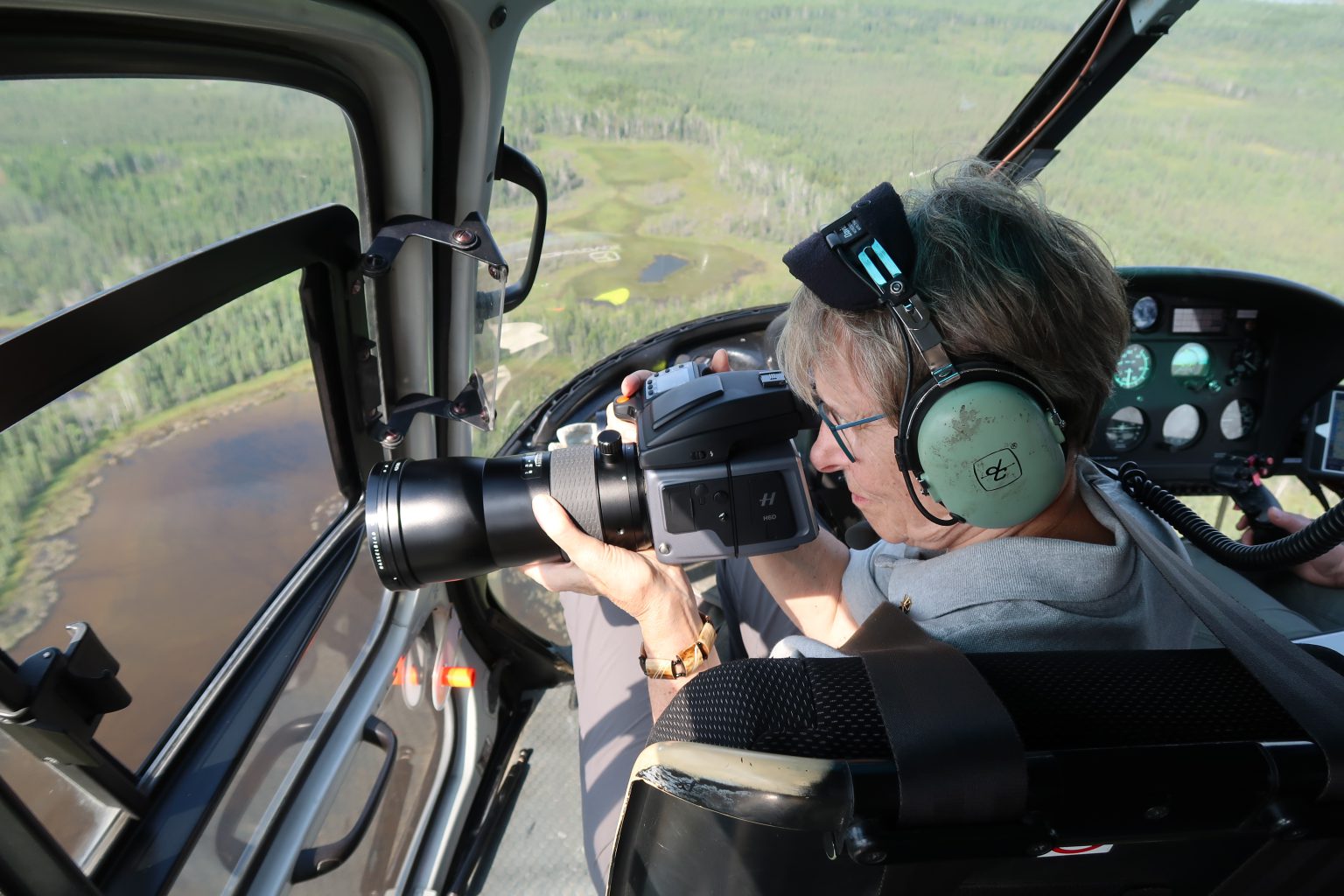 Roberta Bondar photographing whooping cranes from a helicopter, August 2018