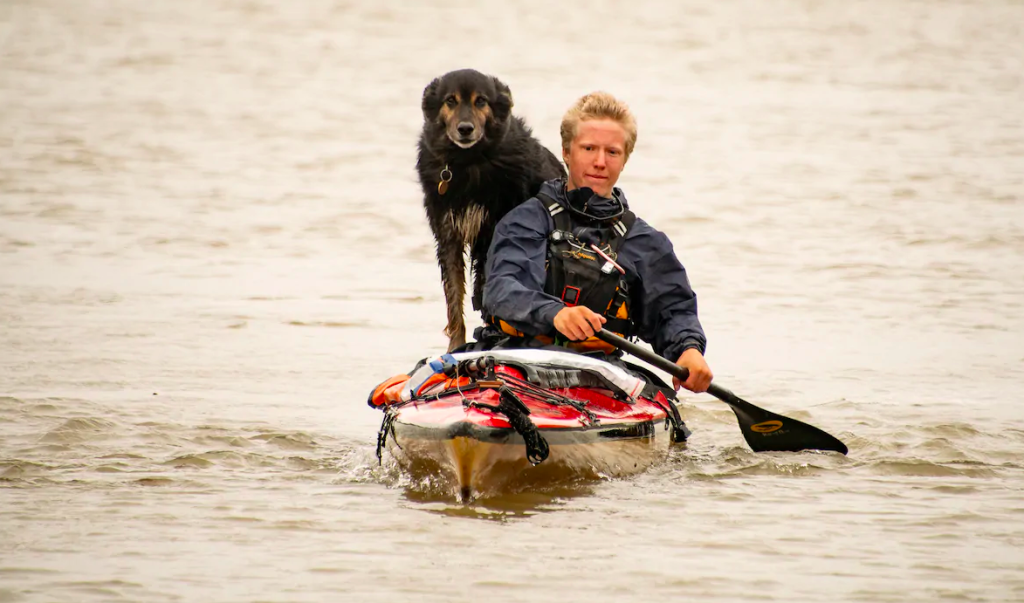 Teen and dog in canoe