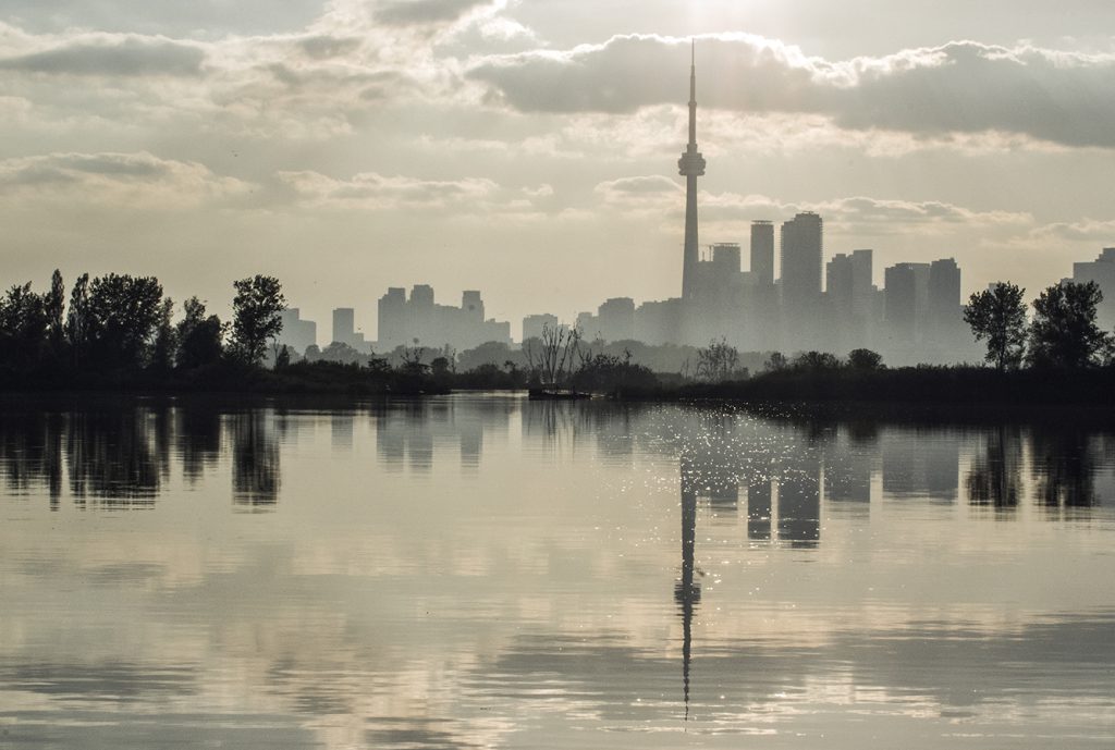Toronto city skyline misty with lake in foreground