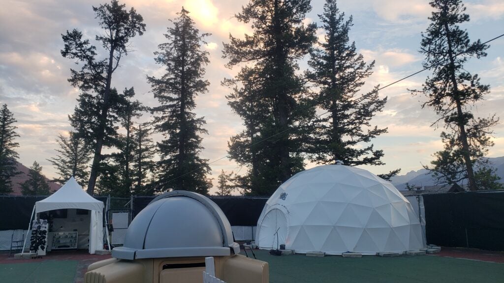 hexagonal domes sit under a cloudy blue sky