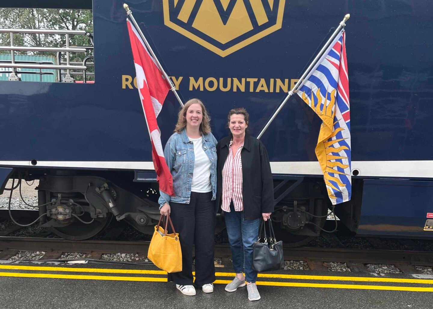 Two women standing in front of a train