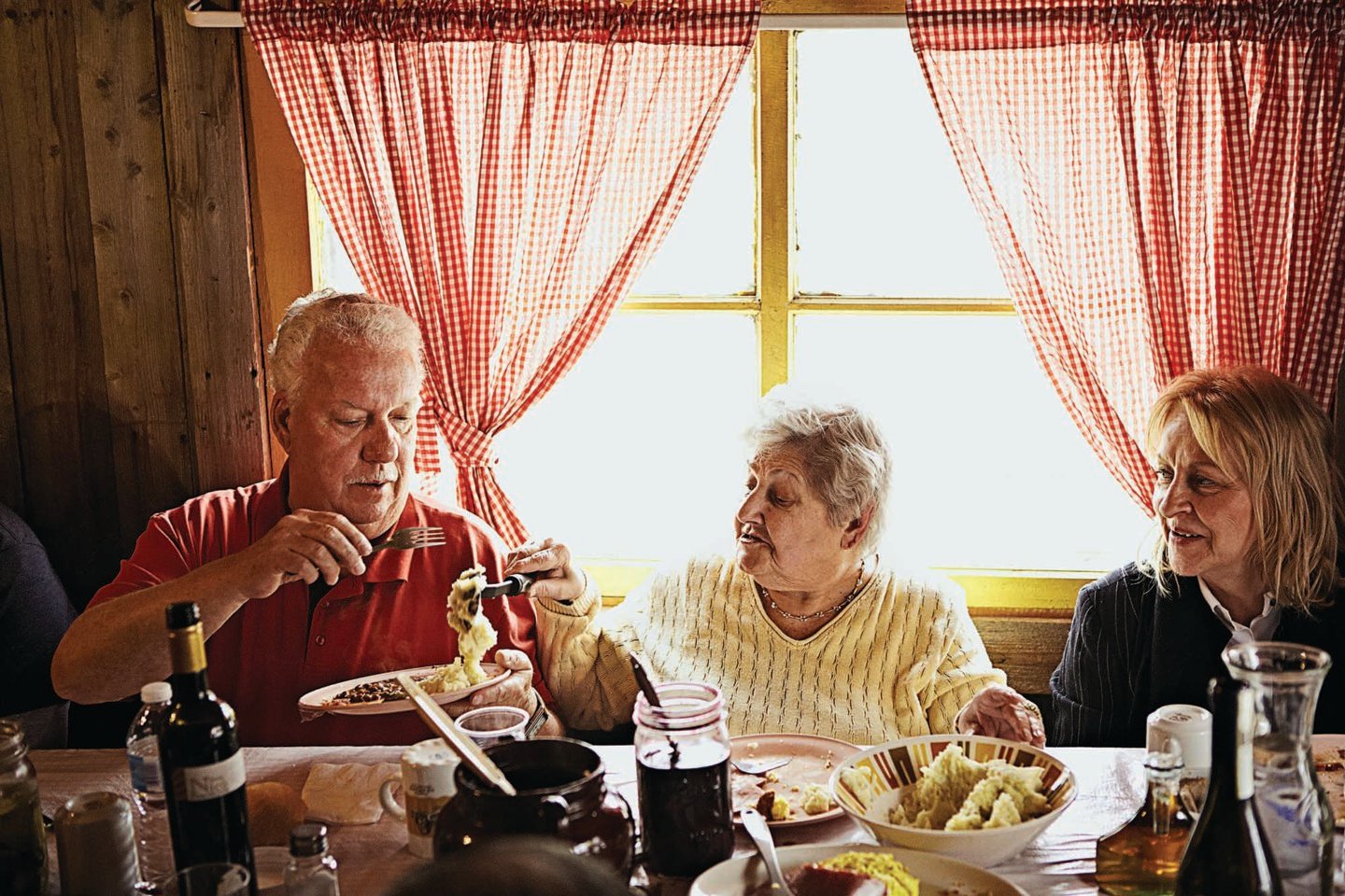 People eat breakfast foods at a sugar shack