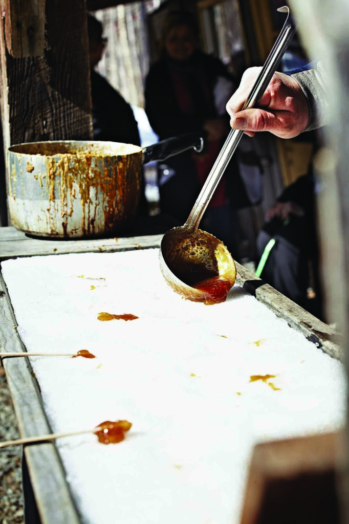 Boiled sap is being poured on snow