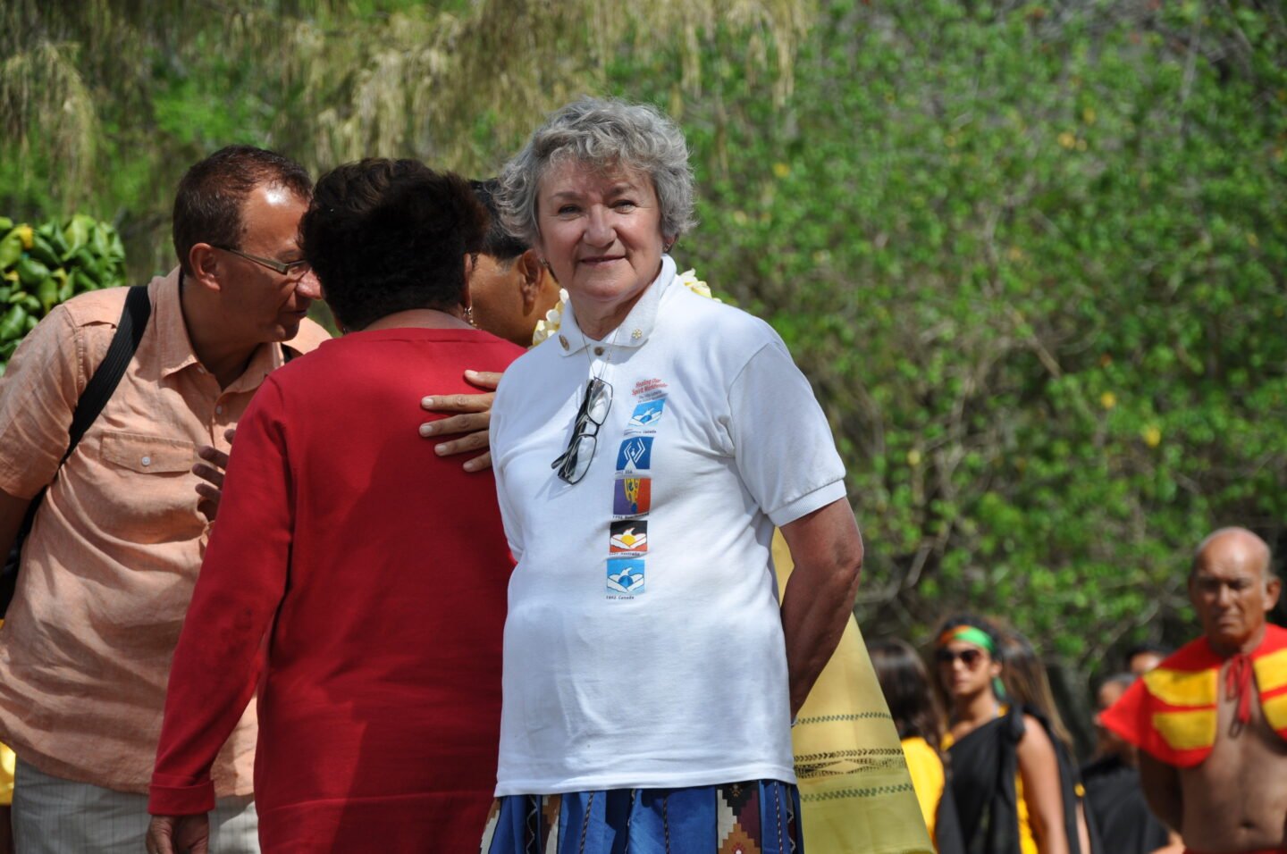 Maggie Hodgson stands in a group of people at the 5th Gathering of Healing Our Spirit Worldwide in 2006