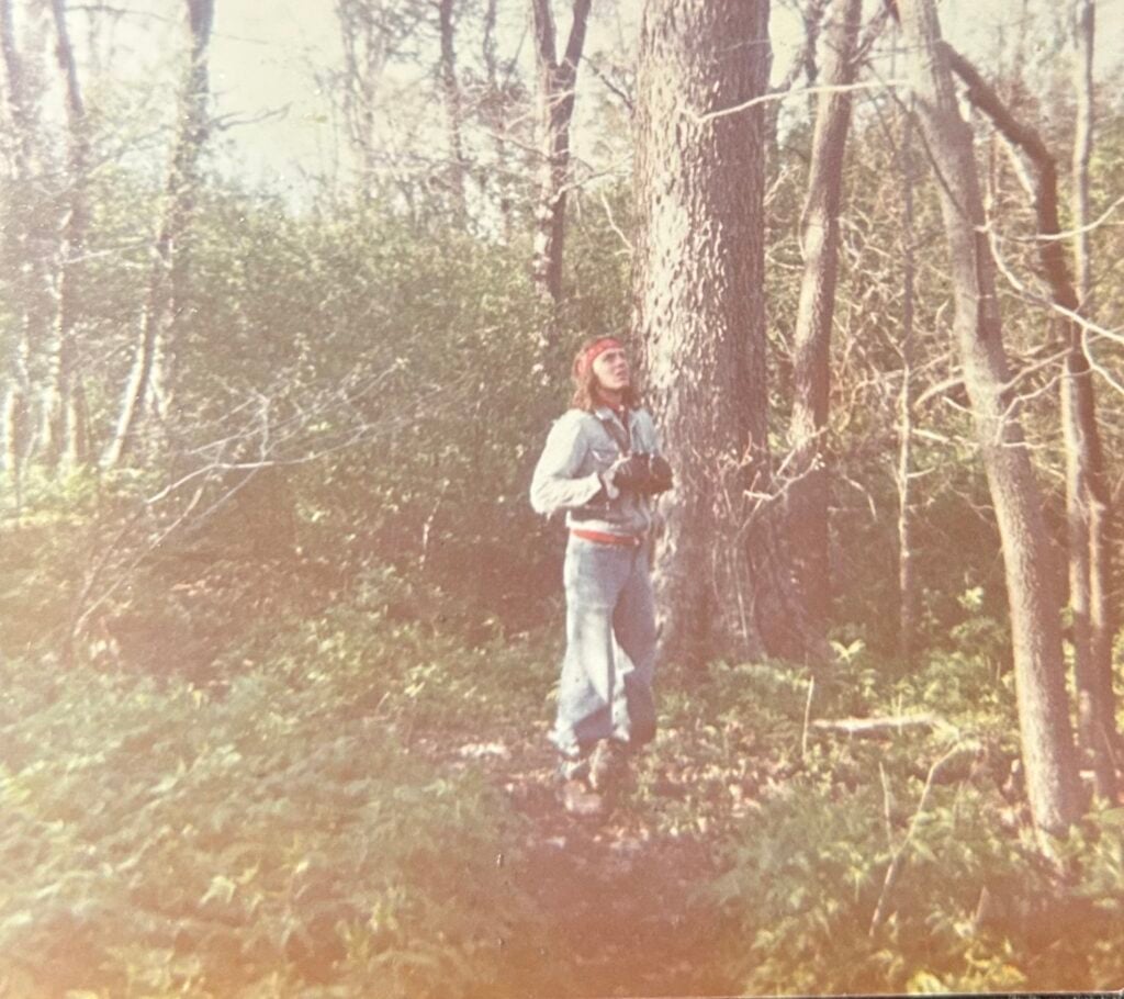 A man stands in the forest in Point Pelee National Park in May 1977