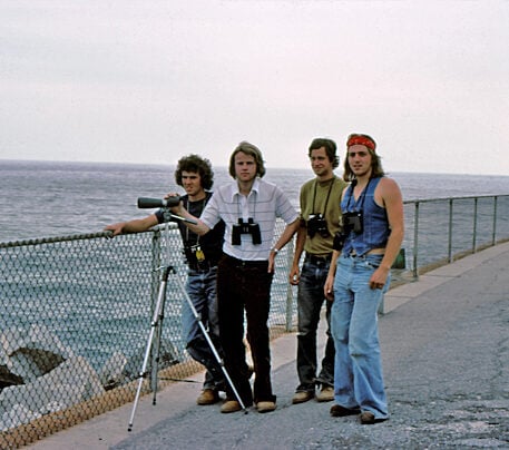 A group of young men standing by the water in Florida